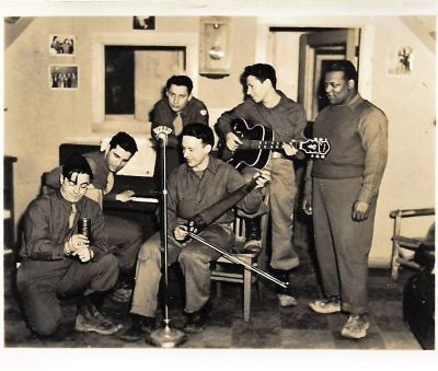 "Artic Antics"

This is a Photo of the Group "Artic Antics". They were a Musical Group assembled by the Army in 1944 to tour all military outposts in Alaska. The seated performer with the saw and violin bow is Allen DeLay, whose estate this photo is from. They were at Shemya Island from November 9th to 15th, 1944.

Would love to identify the others in the photo and return this to a descendant or to a Military Museum in Alaska.
